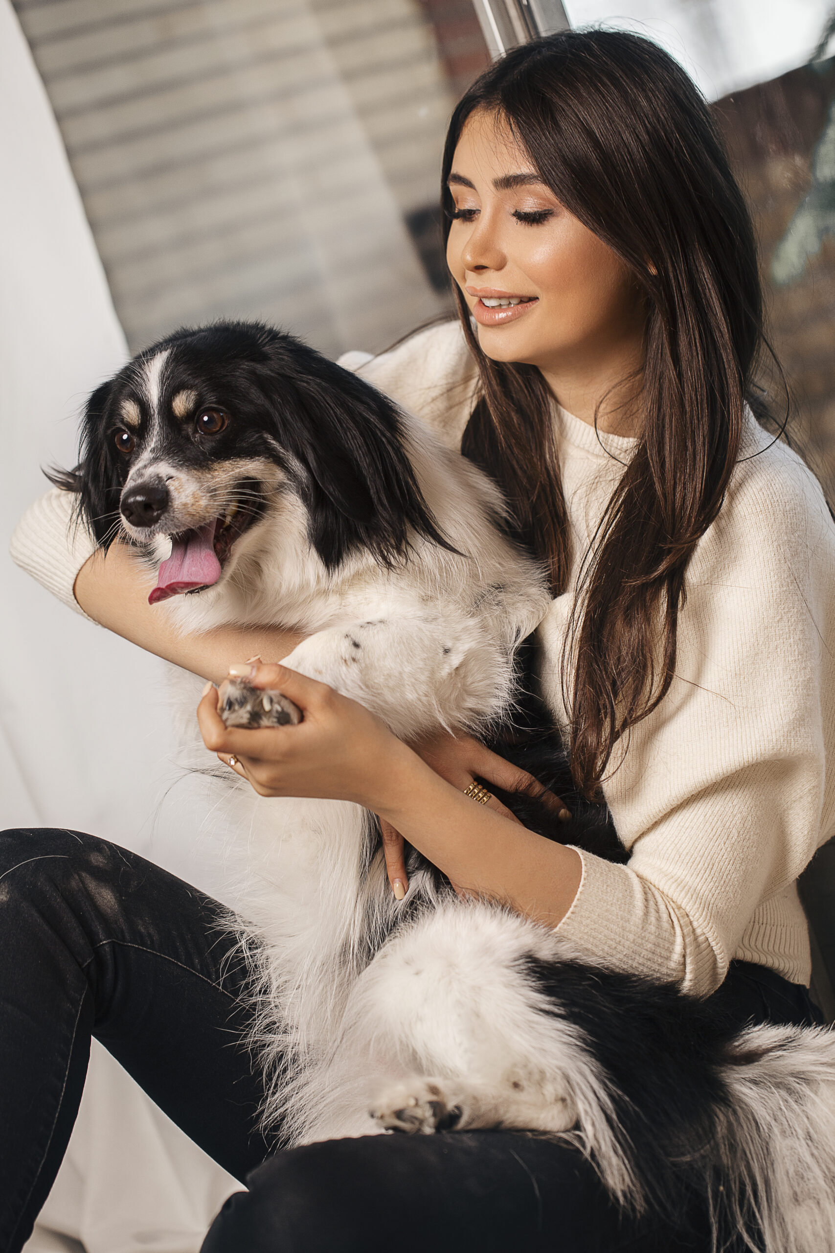 Fashion model in white shirt with black white dog
